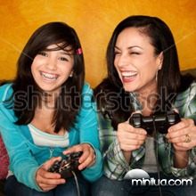 stock-photo-attractive-hispanic-woman-and-girl-playing-a-video-game-with-handheld-controllers-48455071