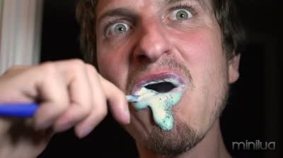 stock-footage-man-brushing-teeth-with-big-eyes