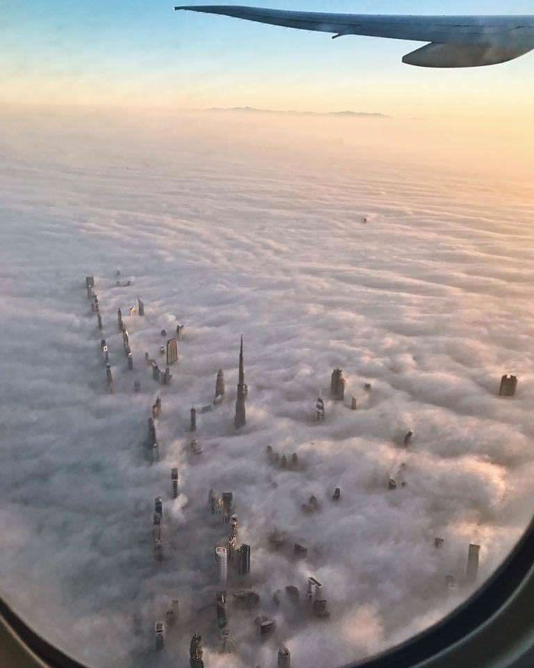 Check out those spectacular skyscrapers and the way theyâre piercing through the fluffy white clouds.