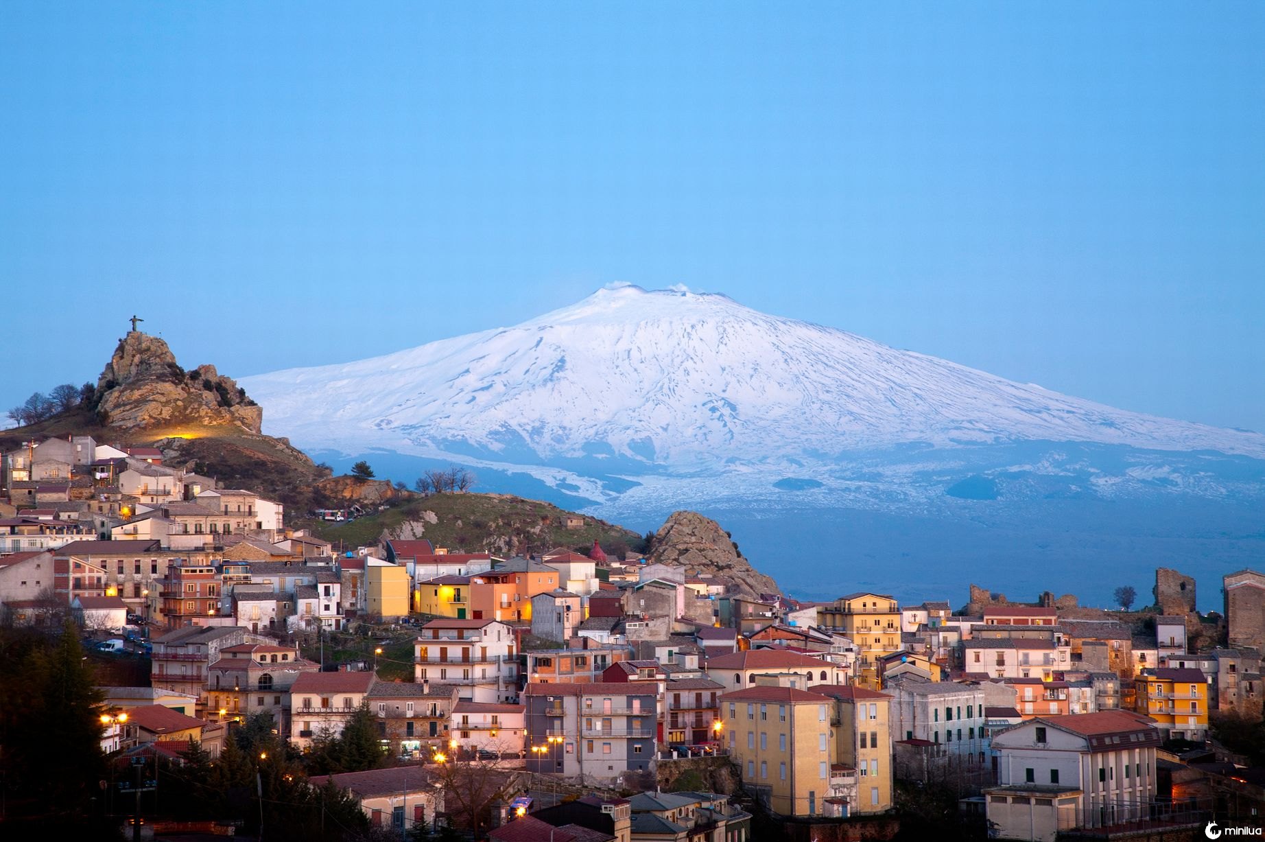View of the village of San Teodoro and Etna volcano on background