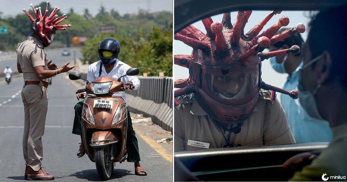 Rajesh Babu, a police officer, wearing a helmet depicting coronavirus, requests a commuter to stay at home during a 21-day nationwide lockdown to limit the spreading of coronavirus disease (COVID-19), in Chennai, India, March 28, 2020. REUTERS//P. Ravikumar TPX IMAGES OF THE DAY