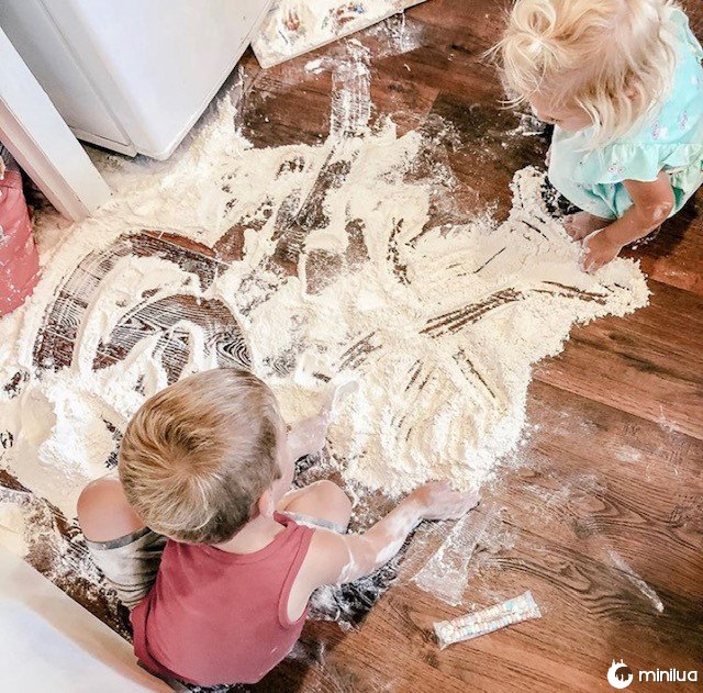 children piling flour on the floor