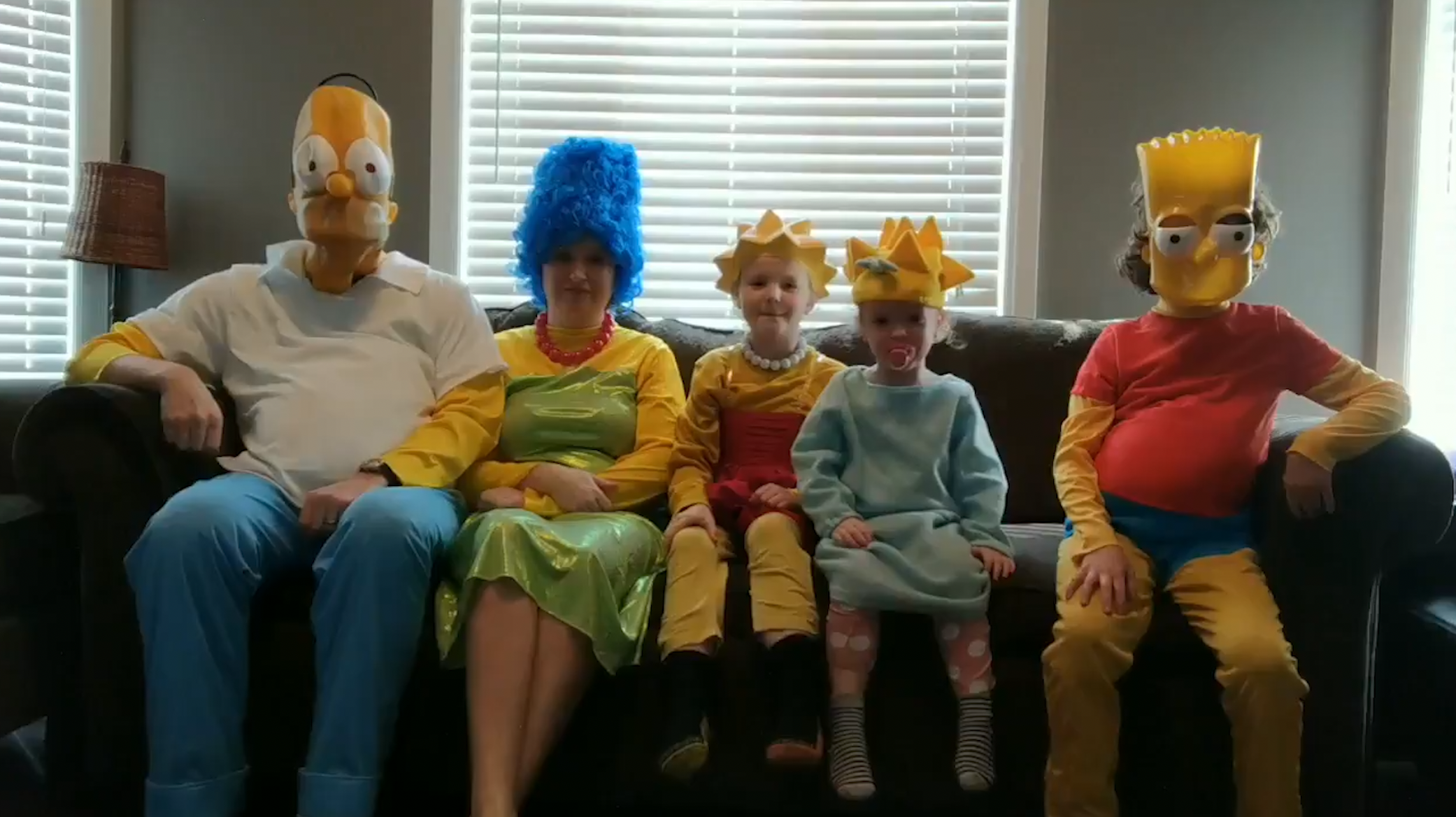 Joel Sutherland and his family dressed as The Simpsons sat on the sofa